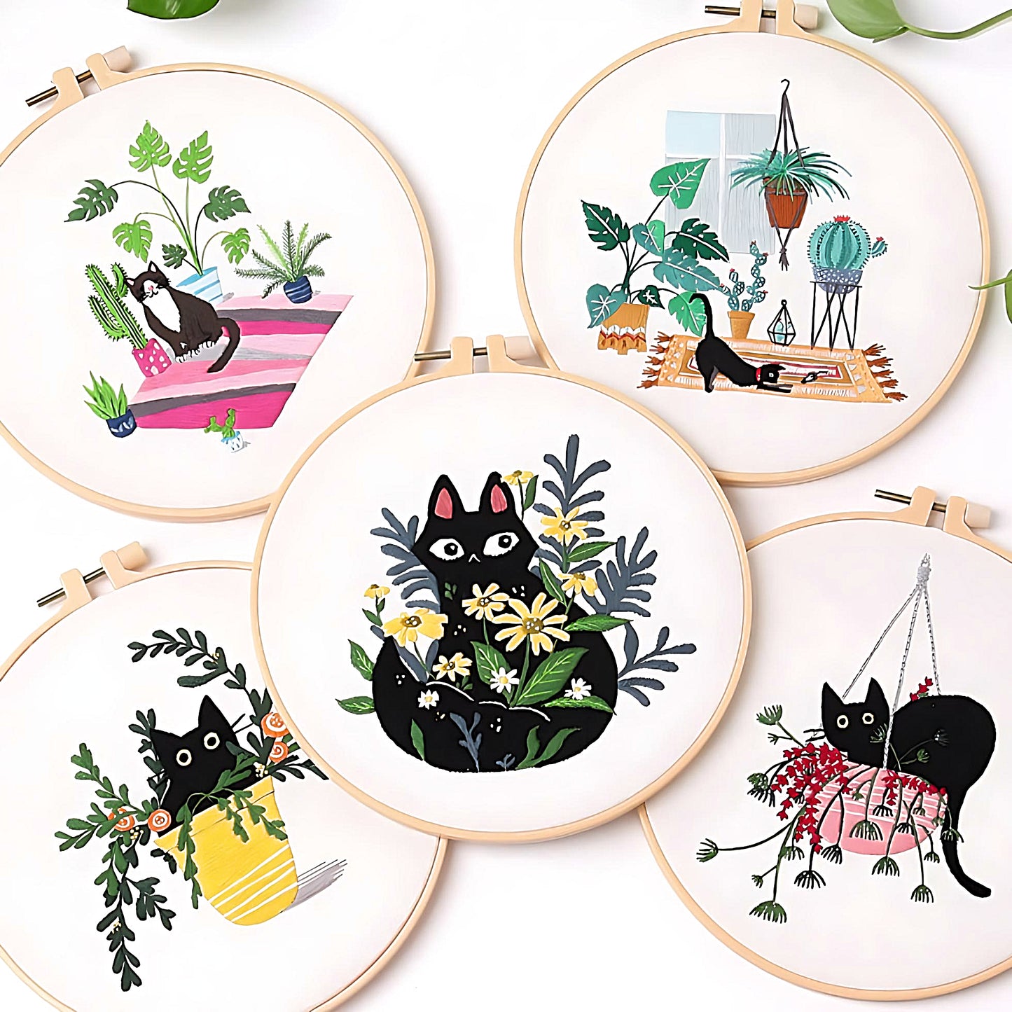five different black cat embroidery sets on a white background